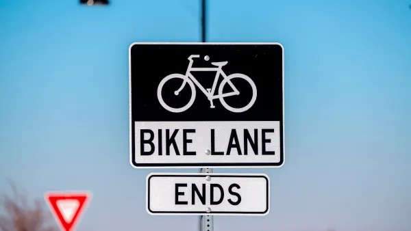 Close-up on black and white "Bike Lane Ends" sign with bike logo.